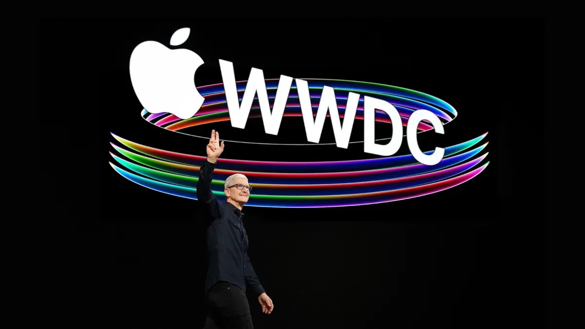 Tim Cook in front of a WWDC sign